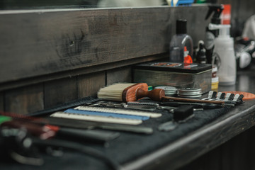 Close up of brushes and comps on barber counter