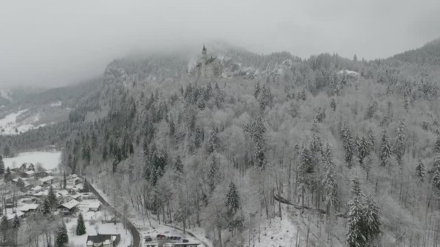 Aerial View Of Neuschwanstein getting altitude while flying towards to the castle