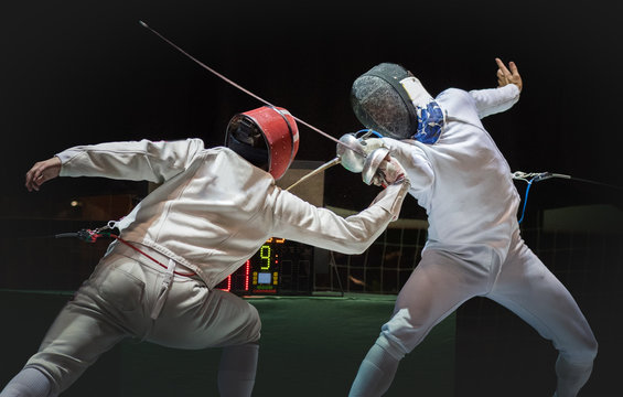 Two man fencing athlete fight on professional sports arena