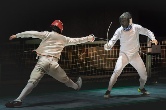 Two man fencing athlete fight on professional sports arena