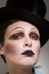 portrait of a girl in top hat and makeup in 20x style with a sad face