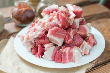 Fresh raw pork sliced on wooden background.
