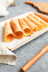 Traditional Christmas Norwegian cookies Krumkake on a kitchen table.