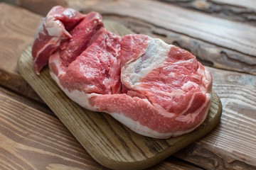 Fresh raw pork on wooden background.