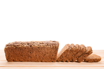Sliced rye bread on wooden table side view isolated