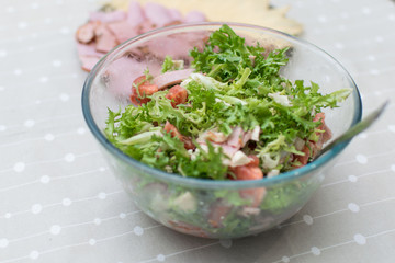 Cooking salad from fresh vegetables and cheese.