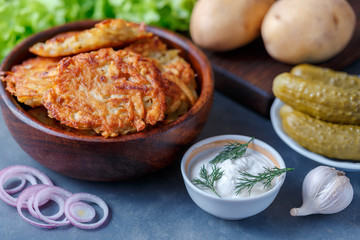Draniki - potato fritters. potato pancakes lie on a plate. The national dish of Belarus, Ukraine, Russia.