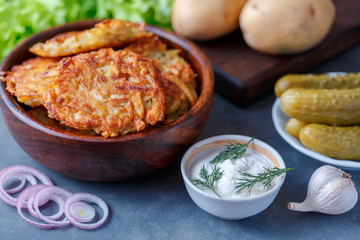 Draniki - potato fritters. potato pancakes lie on a plate. The national dish of Belarus, Ukraine, Russia.
