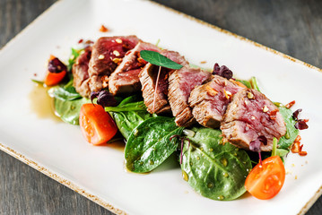 Grilled beef sliced with salad