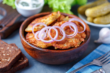 Draniki - potato fritters. potato pancakes lie on a plate. The national dish of Belarus, Ukraine, Russia.
