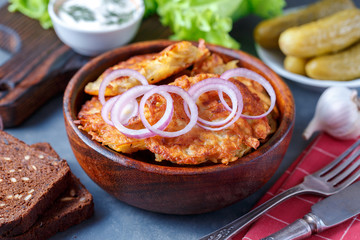Draniki - potato fritters. potato pancakes lie on a plate. The national dish of Belarus, Ukraine, Russia.