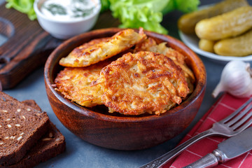 Draniki - potato fritters. potato pancakes lie on a plate. The national dish of Belarus, Ukraine, Russia.