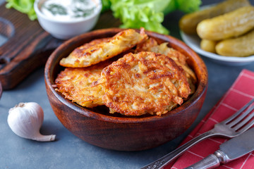 Draniki - potato fritters. potato pancakes lie on a plate. The national dish of Belarus, Ukraine, Russia.