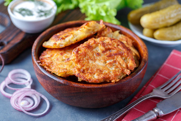 Draniki - potato fritters. potato pancakes lie on a plate. The national dish of Belarus, Ukraine, Russia.