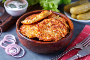 Draniki - potato fritters. potato pancakes lie on a plate. The national dish of Belarus, Ukraine, Russia.