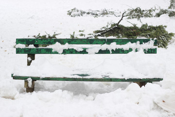 Snow covered park bench winter