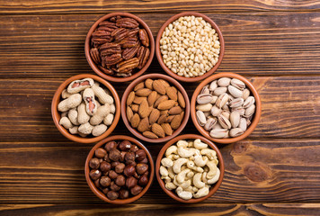 Mix of nuts : Pistachios, almonds , walnuts , pine nut , hazelnuts and cashew . Snack in bowl backgrond