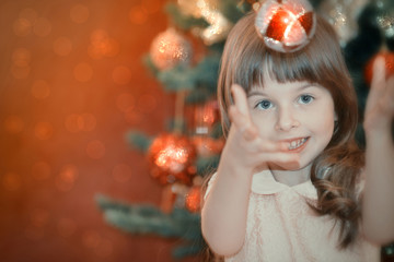 Young girl christmas portrait with red sparkling toys