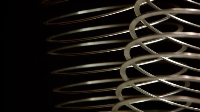 Two metal spring vibrating and moving. Isolated on black background.
