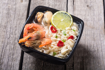 Instant noodles soup with shrimps and mssels . Asian food