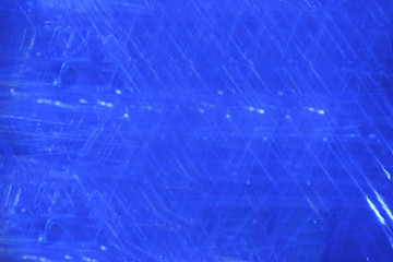 Abstract background of blue shading with white dots and scratchings.