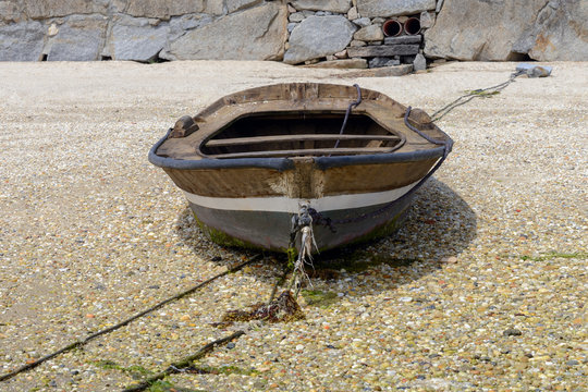 wooden fishing boat is drying on the beach