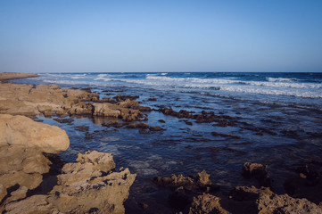 beautiful deserted landscape rocky seashore, blue waves