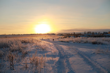 Sunset over the village in winter season