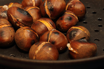 Roasted Chestnuts on a drilled Skillet, closeup view