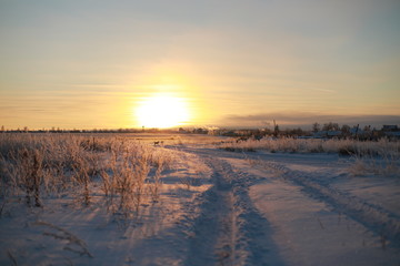 Sunset over the village in winter season