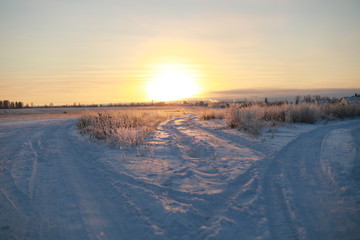 Sunset over the village in winter season