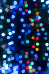 Christmas bokeh of blurry colored circles. vertical photo format