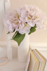 pink flowers, book, mirror in the room interior 
