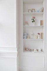 Fototapeta na wymiar white empty chair and cabinet shelves in luxury apartments with wooden floor