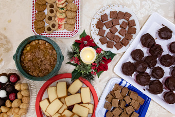 Deserts on a holiday table with candle and pointsetta 