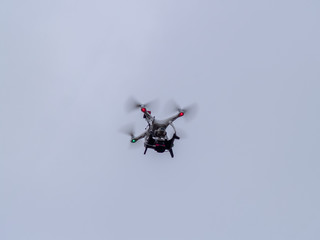 A drone in motion flying in the cloudy sky