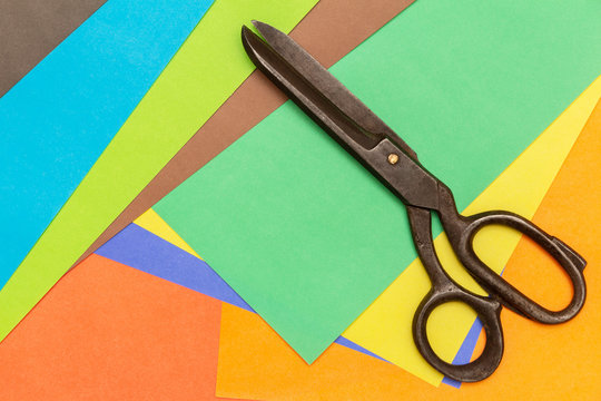 color craft paper and big black scissors. view from above