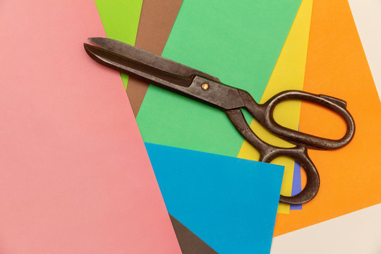 color craft paper and big black scissors. view from above
