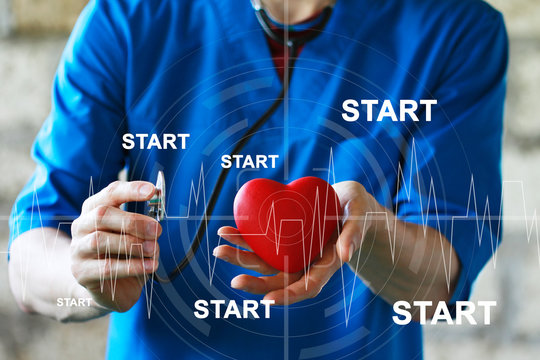 Doctor pushing button start heart pulse healthcare network on internet medical panel.