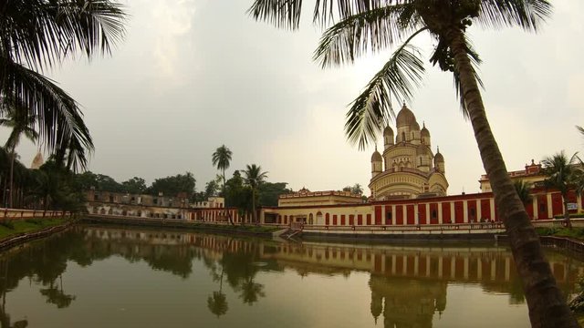 Kali Ma temple with reflaction in pond palms cloudy day Kolkata