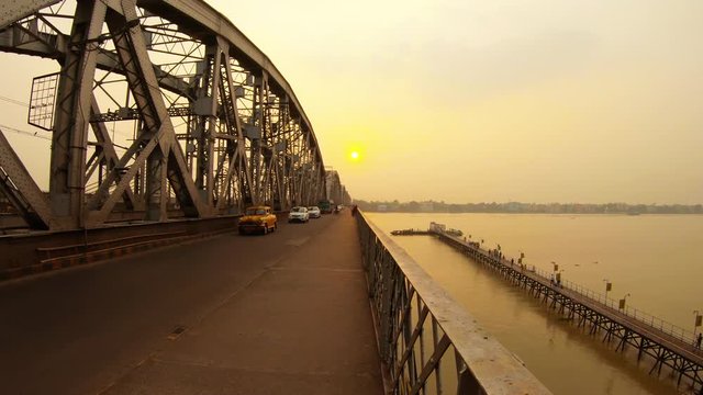 Nivedita cable-stayed bridge old cars cart drive sunset pier on river pink light near Kali temple Ramakrishna mission