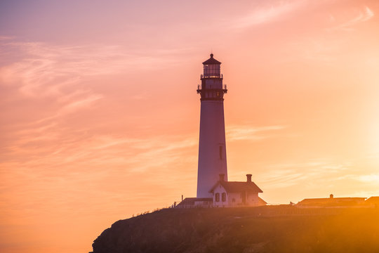 Pigeon Point Lighthouse historical building bathed in sunset light; Pacific Ocean coastline, Pescadero, California