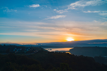 bay of the city of Puerto Montt from the heights at sunrise on a day partially covered with clouds
