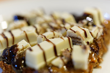 chocolate cakes or commonly known as brownies, decorated with candies, cookies and different sweet sauces