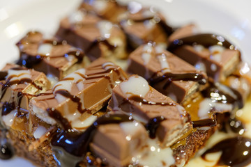 chocolate cakes or commonly known as brownies, decorated with candies, cookies and different sweet sauces