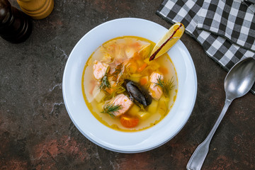 Fish soup on white plate