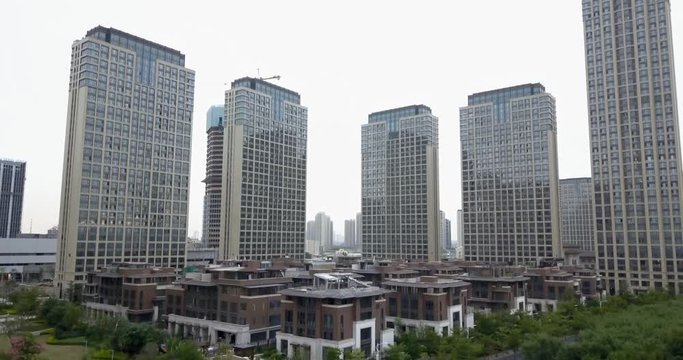 View on brand new area in chinese modern city with tall buildings and villas.