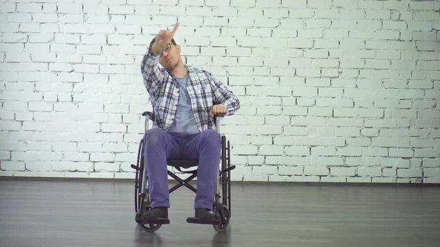 cheerful and positive disabled person dancing sitting in a wheelchair, smiling