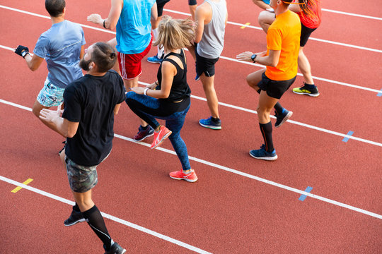 Cropped image side view of a group of sport people