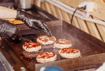 Chef Cooking delicious beef burger on the grill